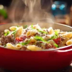 Cremige One Pot Pasta mit Hackfleisch und Tomaten in einem Topf serviert, mit Parmesan bestreut.