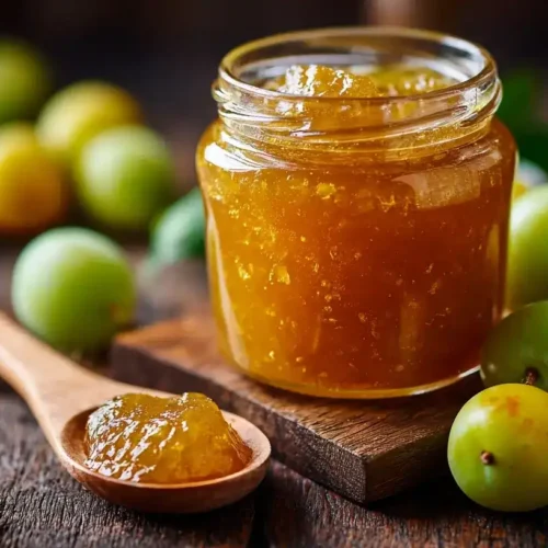 Glas mit selbstgemachter Renekloden-Marmelade und frischen Renekloden im Hintergrund